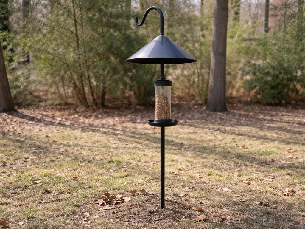 Outdoor pole with a correctly mounted squirrel baffle above a hanging bird feeder.